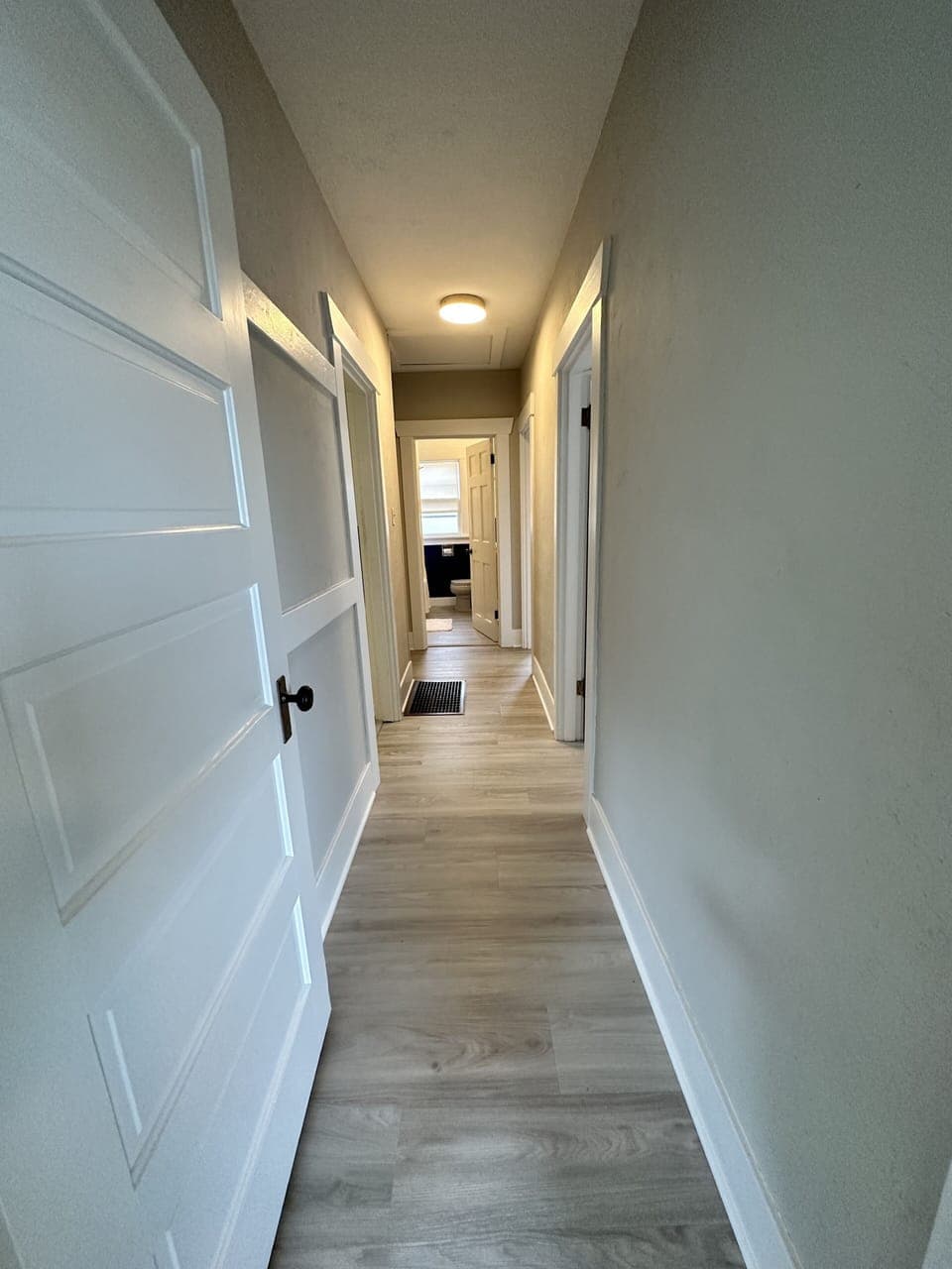 Hallway from front living room & dining area to the bedrooms & bathroom
