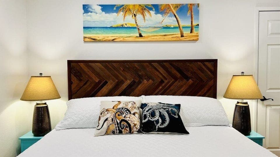 King sized bed with quality linens and pillows can be found in the main bedroom