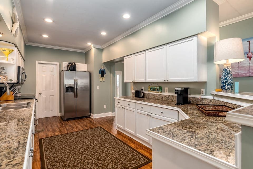 Your spacious kitchen awaits with granite counters, stainless appliances, and everything you need to create memorable meals during your stay.