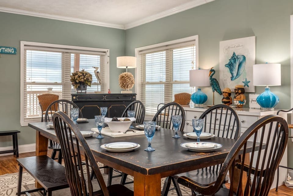 Gather around this elegant dining table where memorable meals and conversations await with coastal charm and natural light.