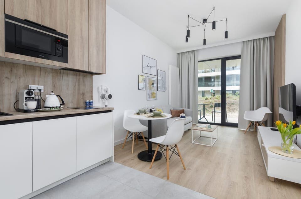 Another perspective of the living room, showing the open-plan layout leading to the dining and kitchen area.