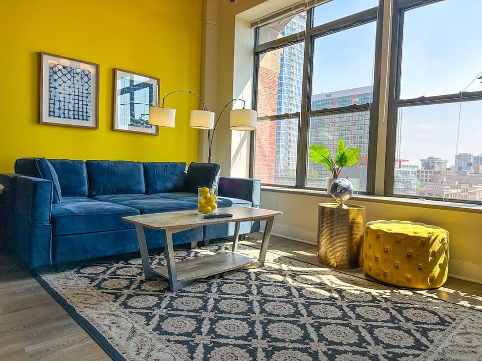 Spacious living room with a lot of natural light and large windows.
