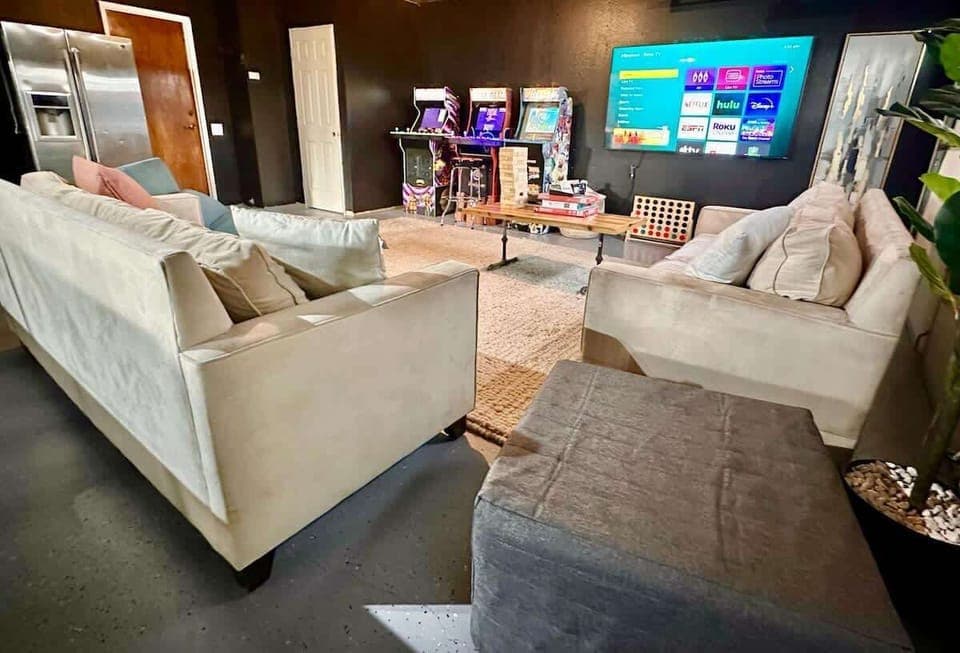 The ultimate entertainment space with a variety of arcade games, board games, and a TV perfect for a movie marathon. Cozy couches and a stylish wood-finish table, and a double-door fridge for your snacks and drinks - perfect room for endless fun.