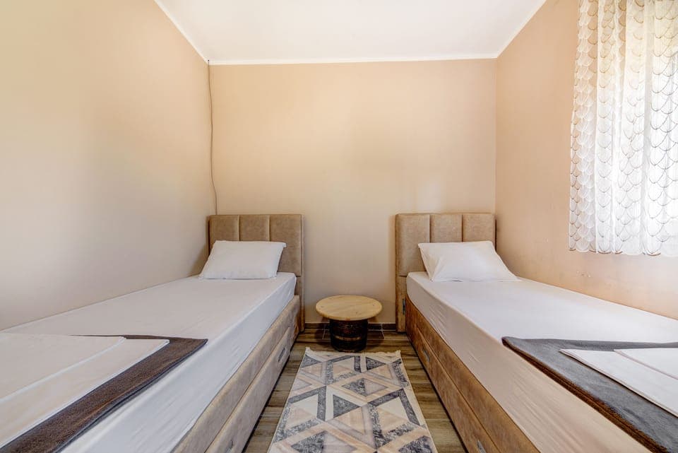 The second bedroom is furnished with two single beds.