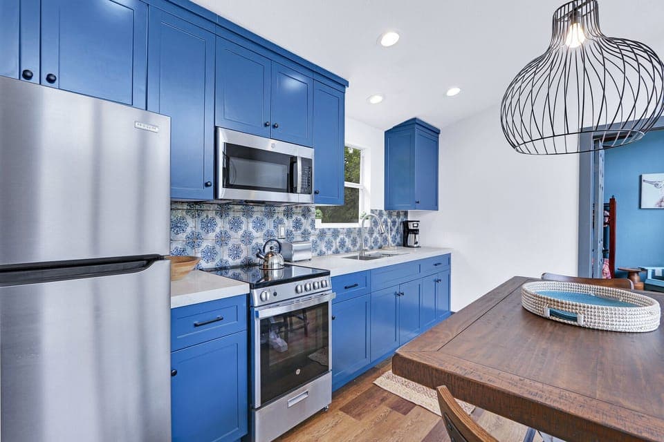 Kitchen has stainless appliances-- refrigerator, microwave, range with oven.