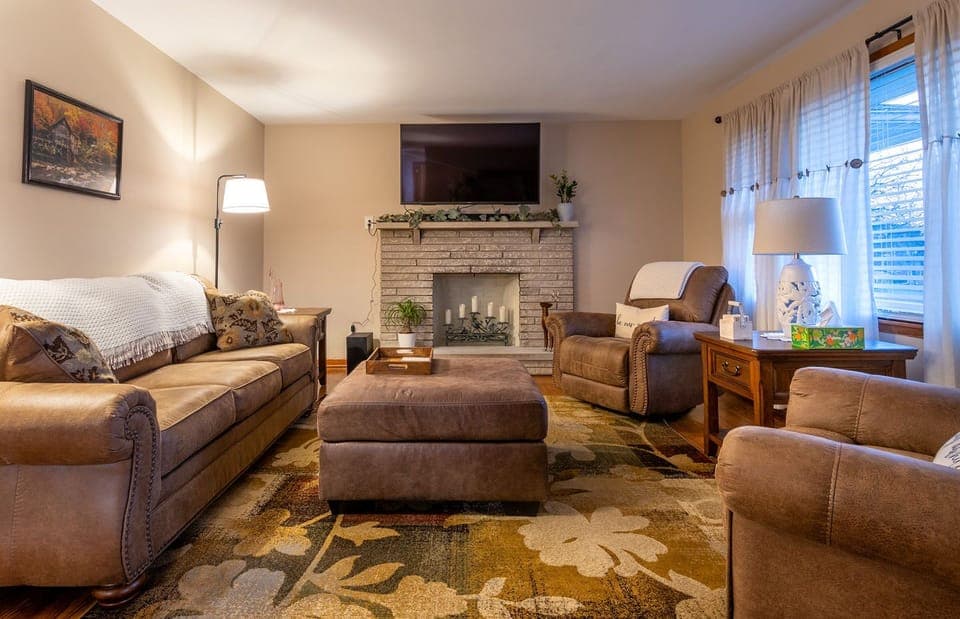 Cozy relaxing living room with decorative fireplace and smart TV