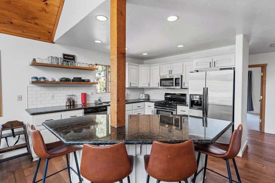 Open kitchen area with bar seating. 