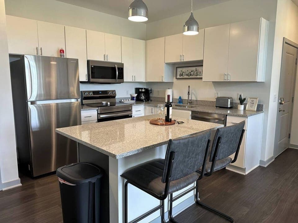 Spacious kitchen with brand new appliances and lots of counter and cabinet space, generously stocked with kitchenware! 