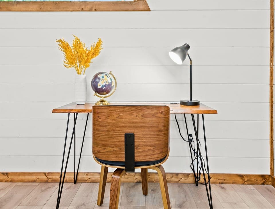 This workspace features a minimalist design with a wooden desk and modern chair, perfect for productivity.