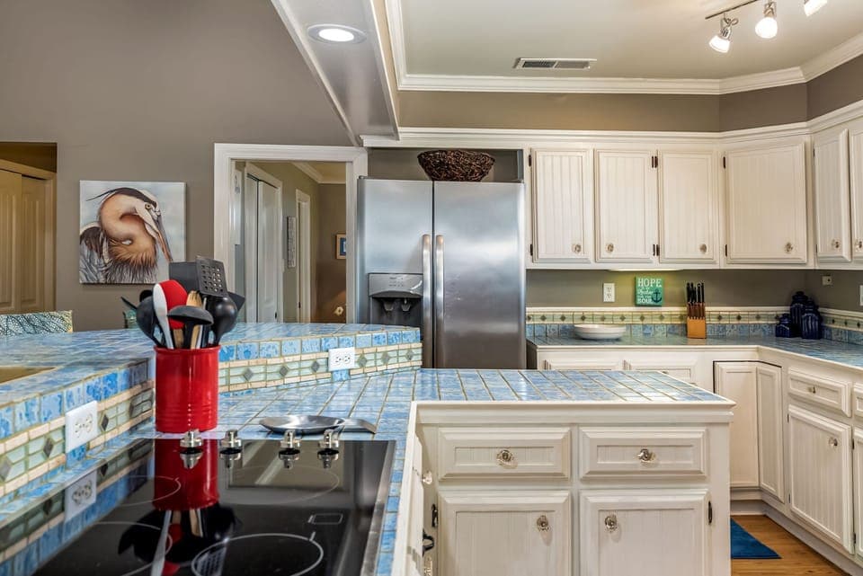 Cook memorable meals in this spacious, fully-equipped kitchen featuring granite counters, stainless appliances, and ample cabinet storage for all your culinary adventures.
