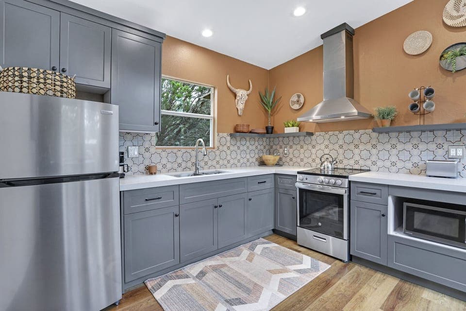 The cabin has a modern kitchen with stainless range/oven combo.