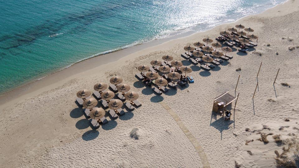 On the beach, white sand, sun loungers, beach umbrellas