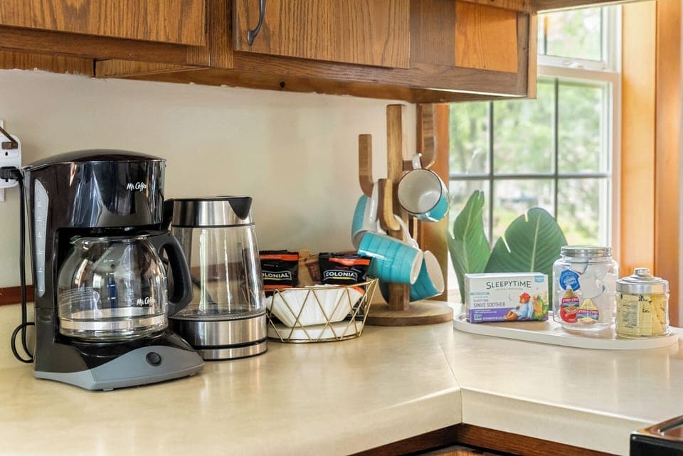 Coffee station with drip coffee maker and electric kettle.