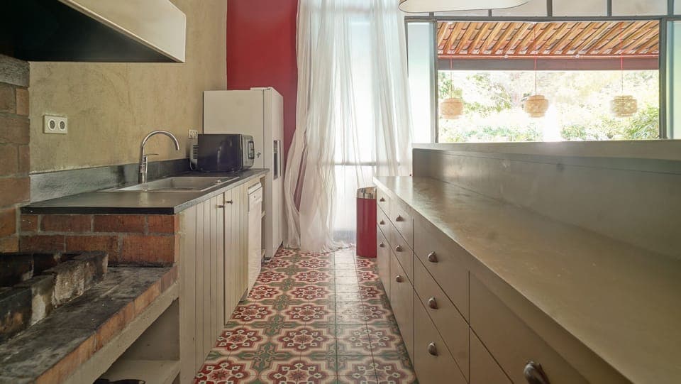 La cuisine ouverte du poolhouse, avec son barbecue intérieur