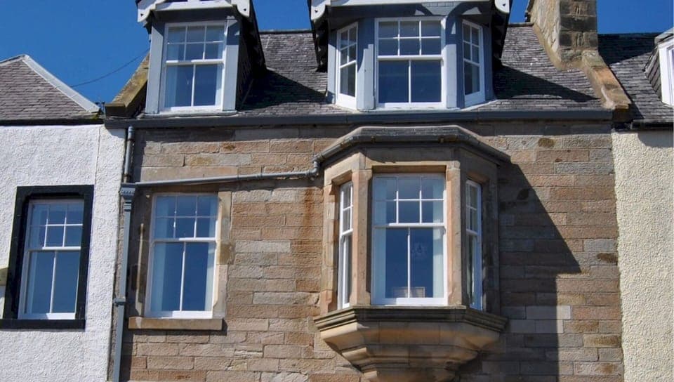 The accommodation is on the upper two levels of a traditional harbourfront home