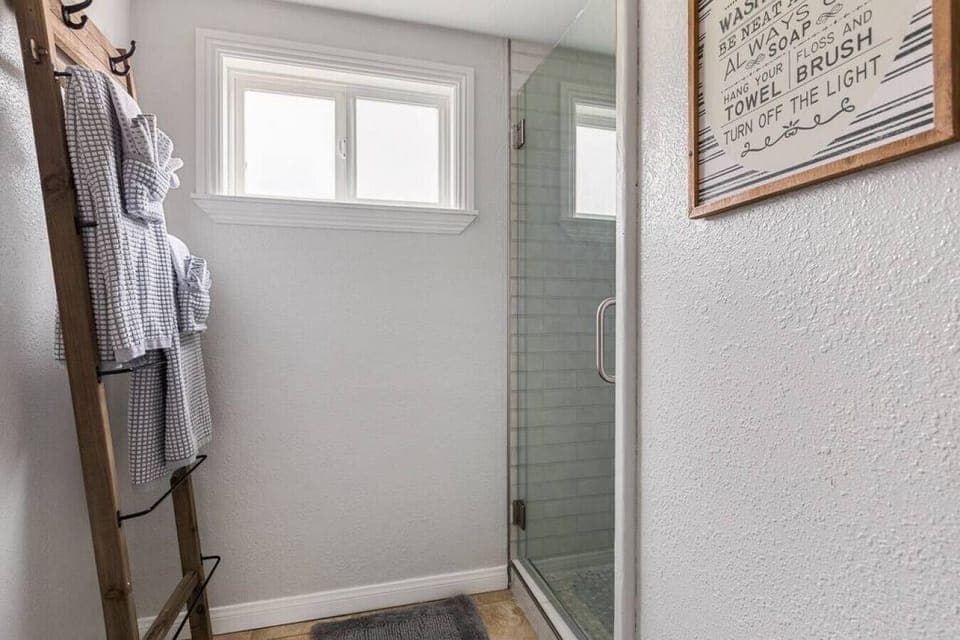 Bathroom with a stand in shower and toilet.