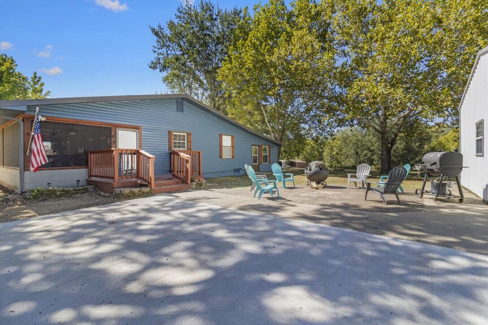 Exterior with large yard and fire pit and pellet bbq grill. Circle drive for easy boat parking.