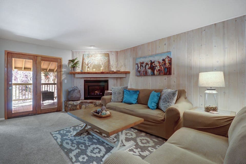 Warm and cozy living room with plenty of seating near the fireplace.