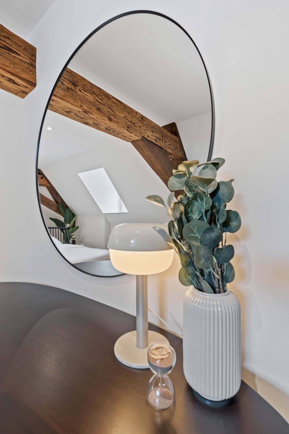 Enhance your stay with our chic vanity area, complete with a stylish round mirror and modern lamp, perfect for your daily routine.