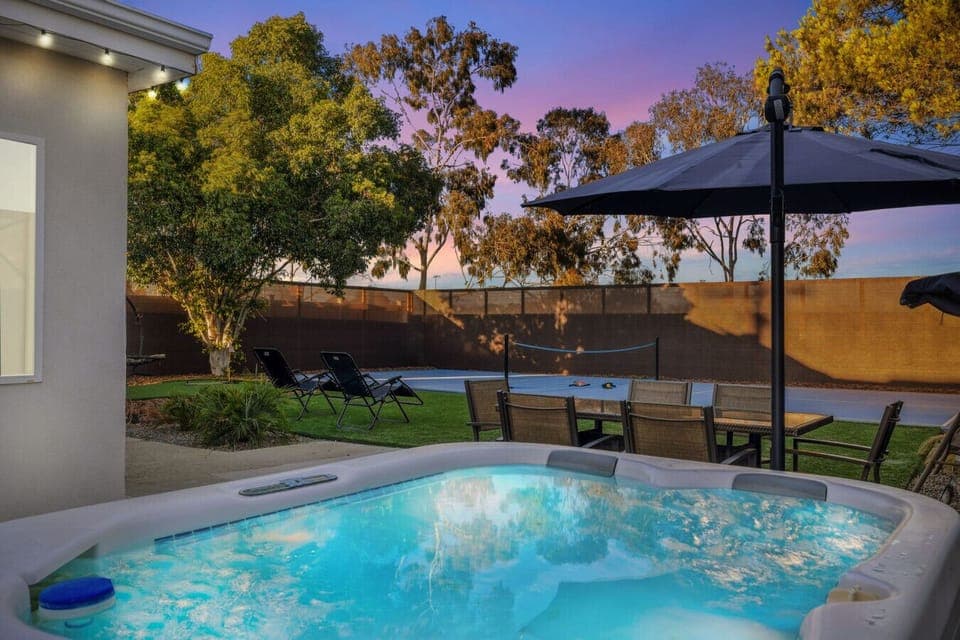 Unwind in the private hot tub or gather for outdoor dining under the lights.