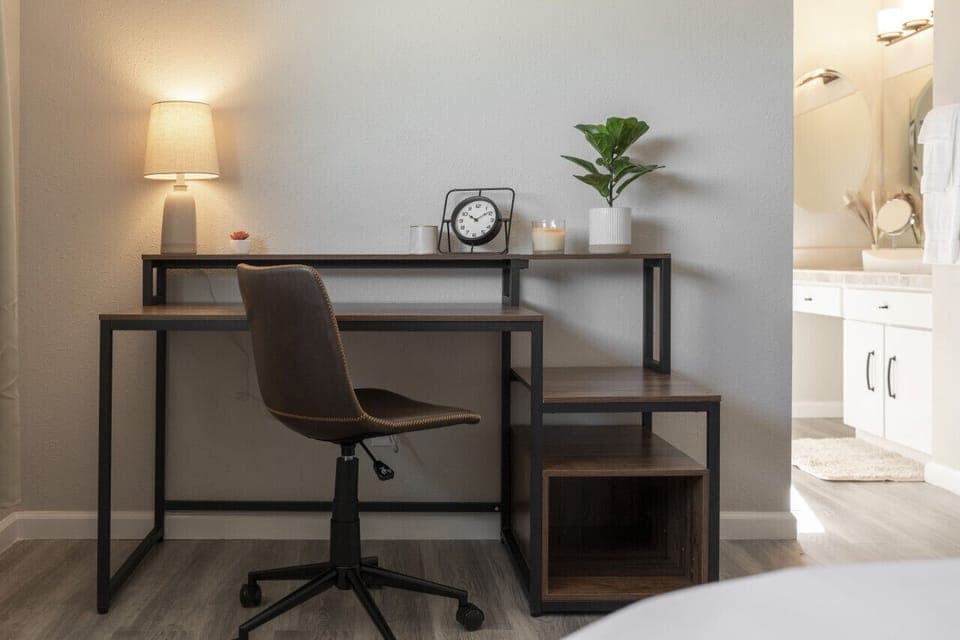 This bedroom offers a stylish desk, perfect for emails and creative work.