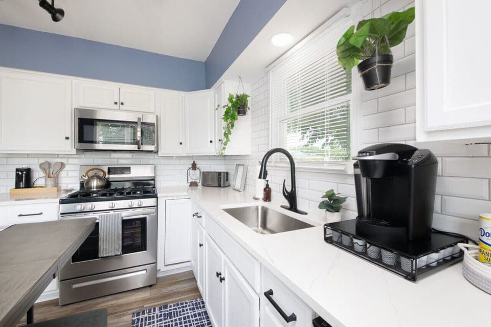 Whip up meals in this modern kitchen 🍳🌿 Stainless steel appliances, Keurig coffee station, and tons of natural light make cooking here a joy. Fresh, functional, and fully stocked! ☕🔪