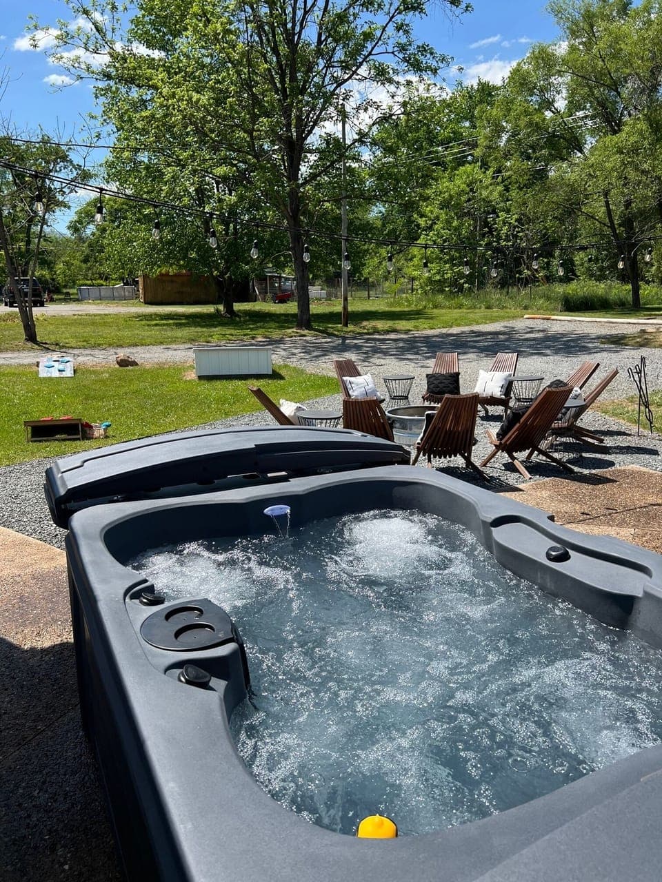 Private backyard hot tub under twinkle lights — perfect year-round