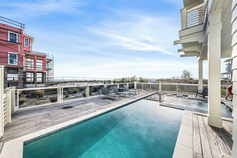 Relax by the water on this spacious pool deck, perfect for sunbathing and coastal dreaming