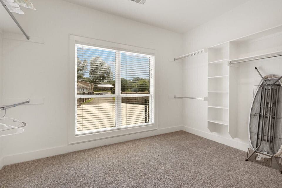 Spacious walk-in closet with plenty of storage and natural light.