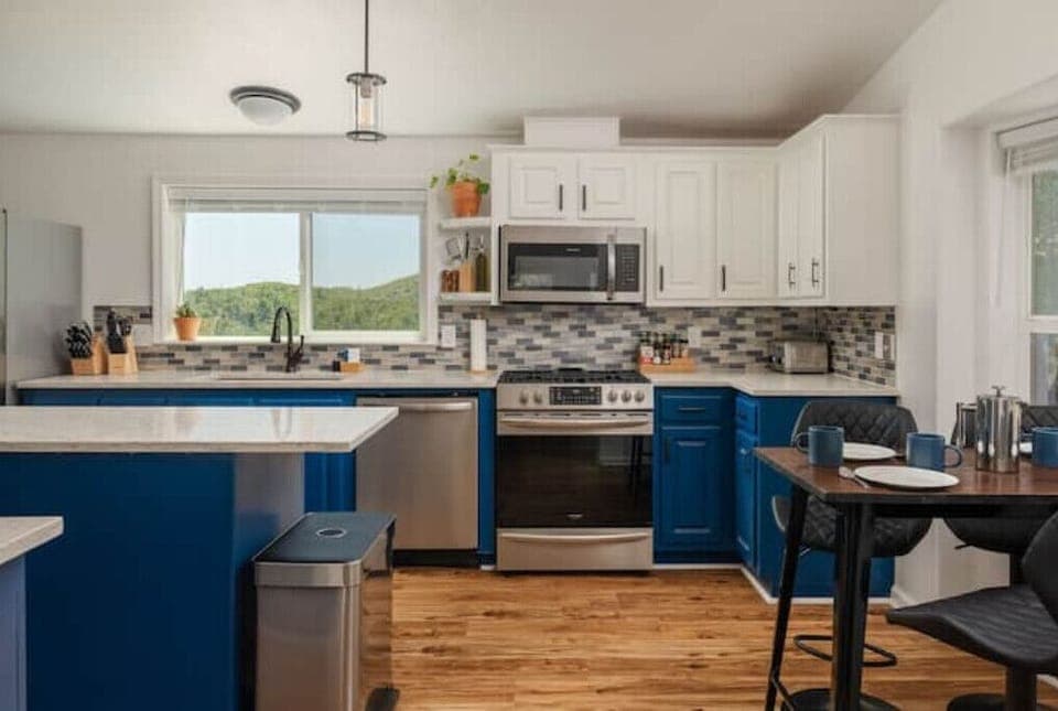 Fully-stocked kitchen with olive oil + many spices for all cooking needs. 