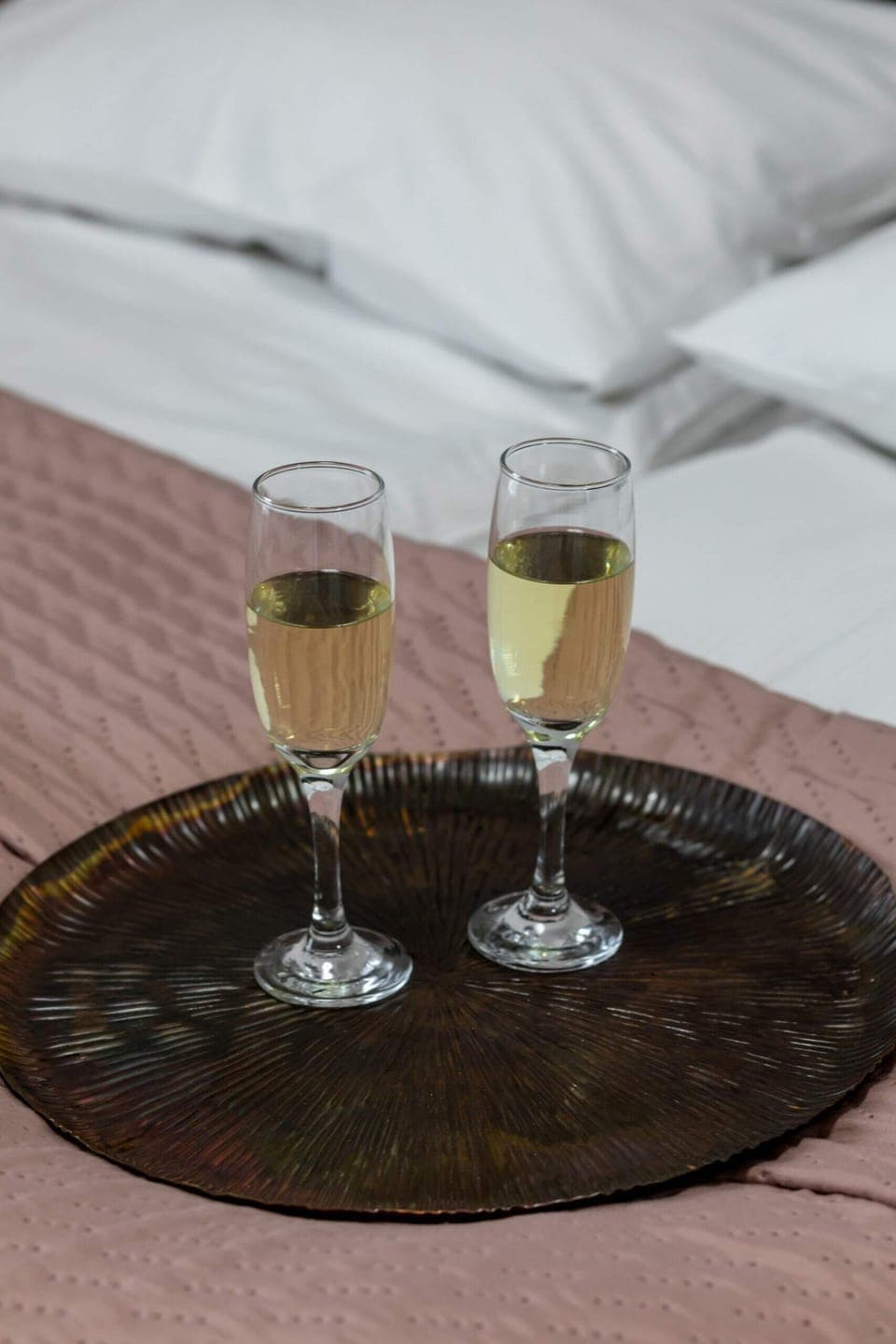 A romantic touch with two glasses of champagne served on the bed for special moments.

