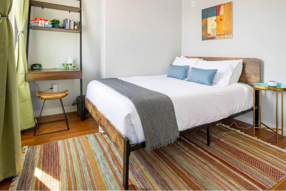 Handwoven rug, queen 12in thick memory foam mattress. Dedicated workspace. Cards, games and reading.