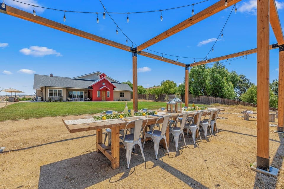 Large, open-air dining table overlooking the private soccer field.