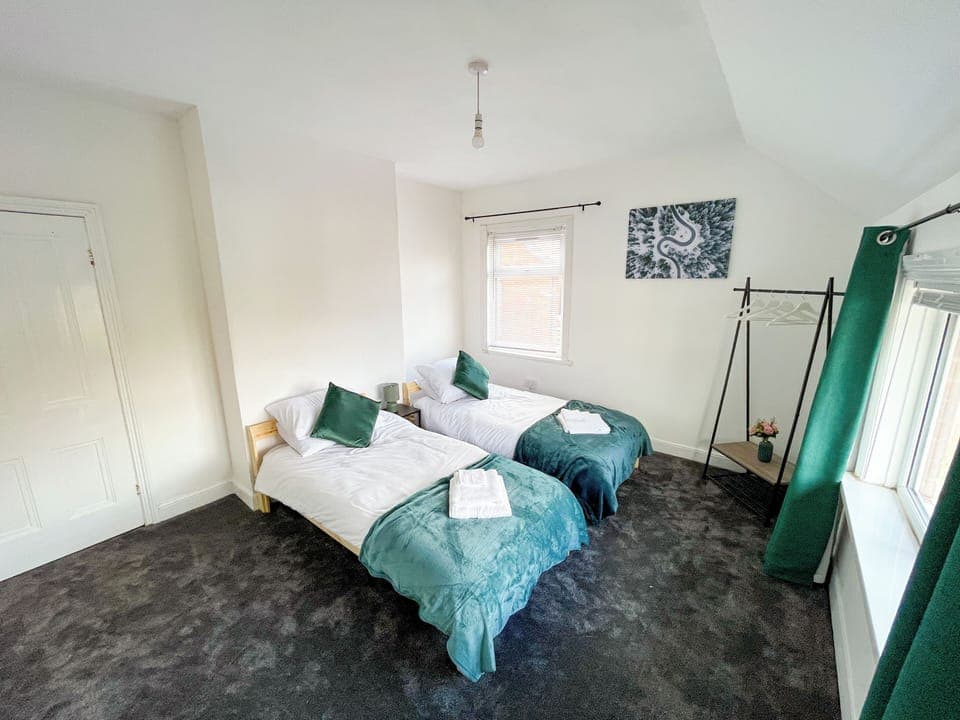 2 Single beds with wardrobe, linen & towels.