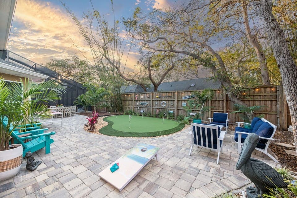 HUGE backyard with seating for all, mini put, over 2000 sq ft of paver patio!