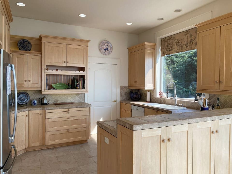 Fully furnished kitchen complete with tile countertops and marble floors.