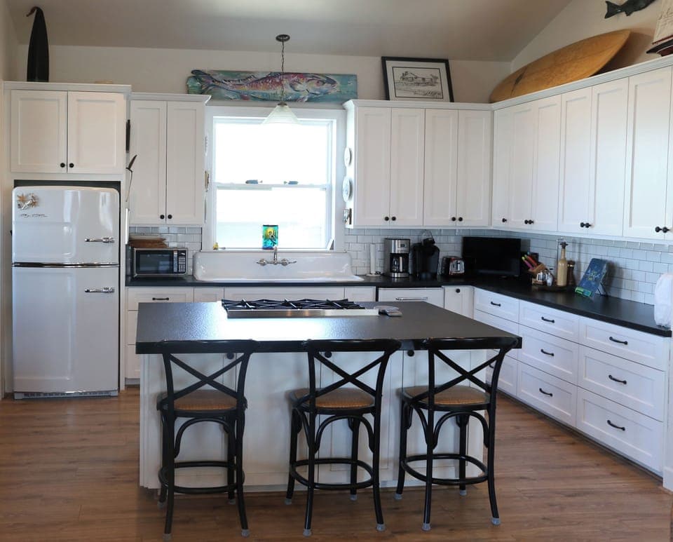 Kitchen, with bar stools to seat 3