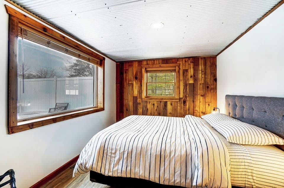 Bedroom 2 with queen bed and unobstructed lake views.