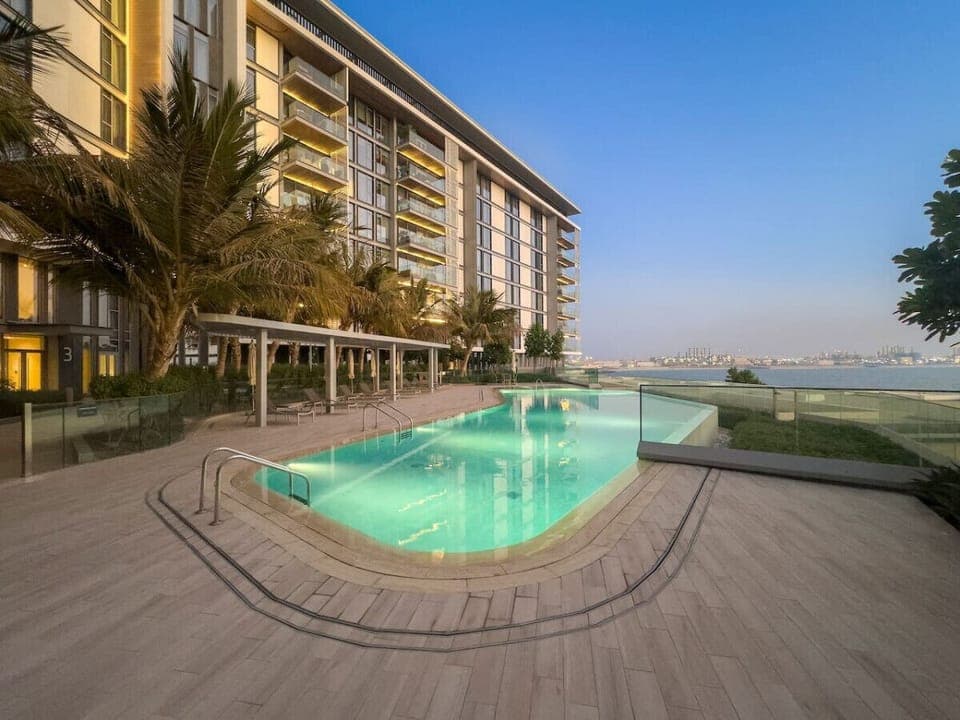 Exterior Oasis: Dive into luxury with our shimmering pool and stunning waterfront views!