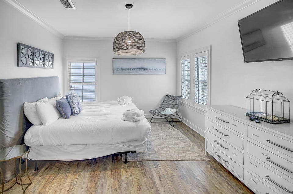 Second Floor King Bedroom-Indulge in luxury on the second floor with a king bedroom boasting an amazing attached bathroom. This bedroom includes a dresser, closet and large mounted tv. 