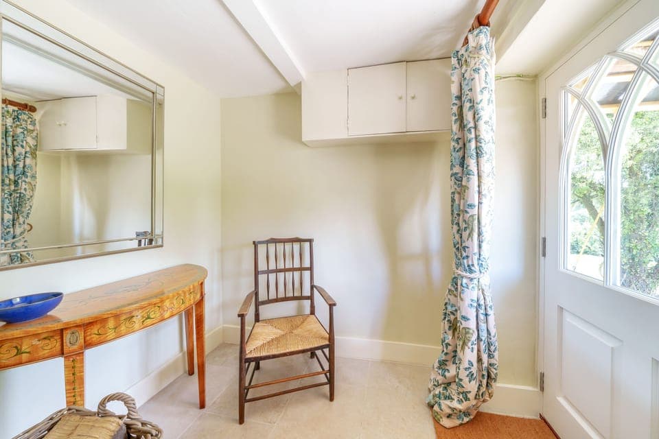 Cosy Cottage, Chebbard, Dorchester:  The front porch with logs, space for your shoes and coat hooks.