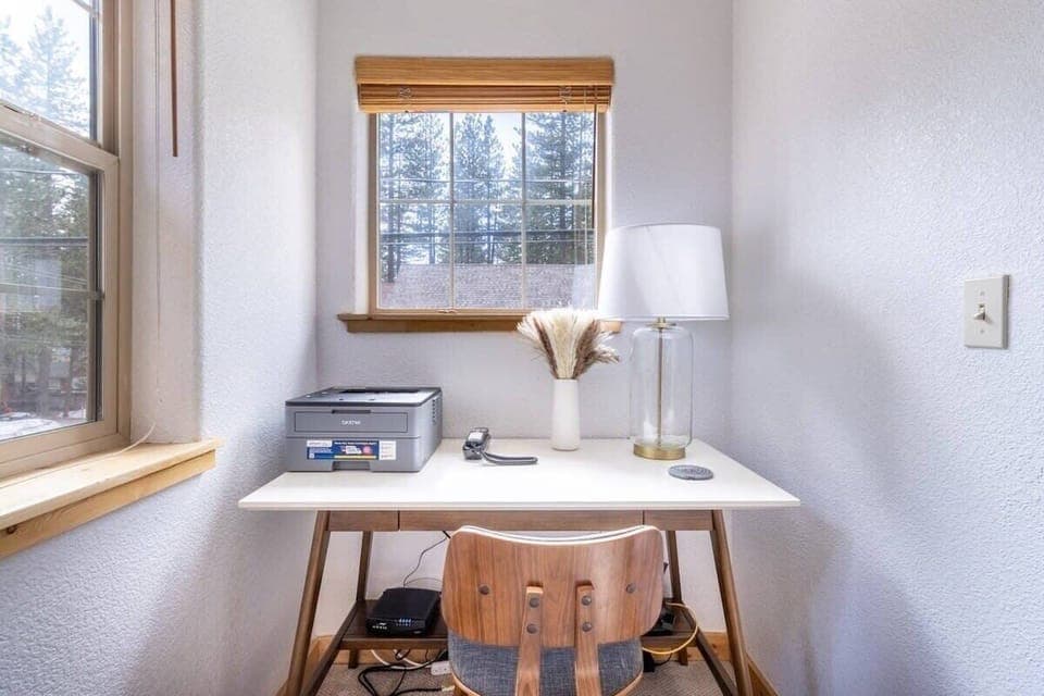 Keep up with any remote work needs in the bright workspace found in the master bedroom which includes a desk, chair, and printer.