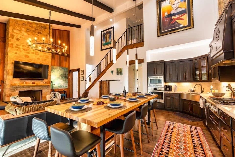 Large open living room and fully stocked kitchen. Custom Pecan wood dining room table with leather chairs that can seat 10 guests comfortably. Gather around for a nice cup of coffee and breakfast in the morning, and dinner and wine in the evenings! 