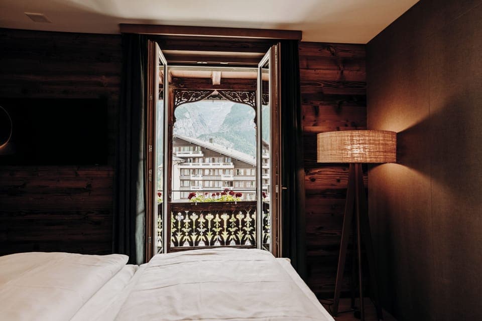 Chalet suite, balcony, mountain view | Hypo-allergenic bedding, in-room safe, desk, iron/ironing board