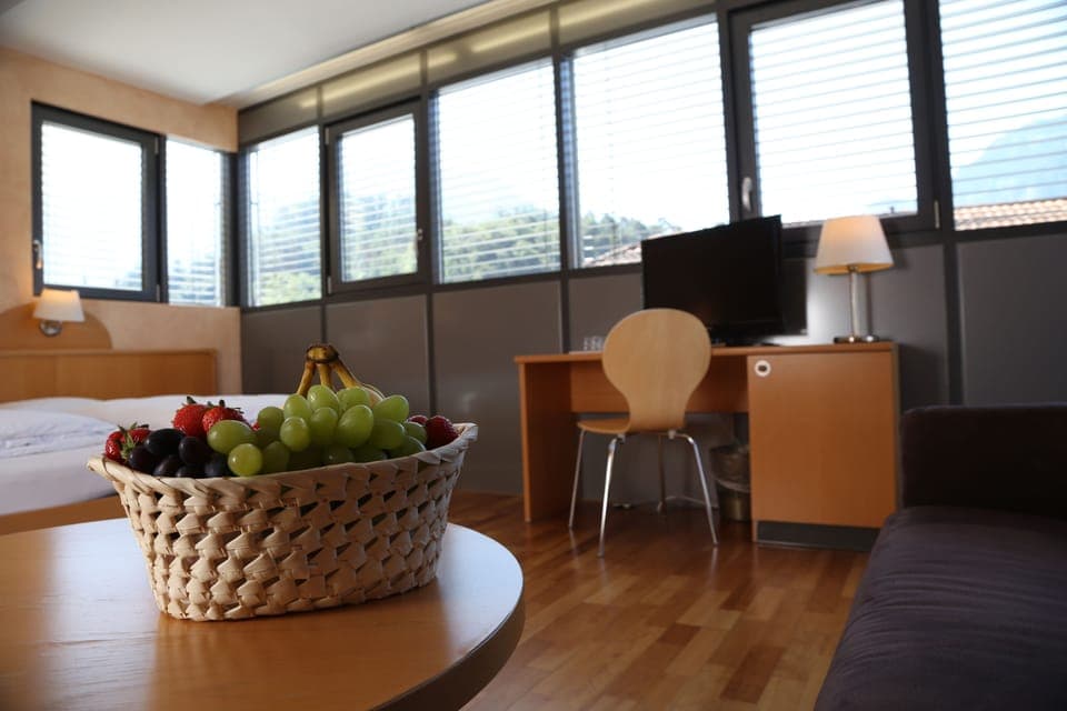 Deluxe Quadruple Room | Minibar, in-room safe, desk, blackout drapes