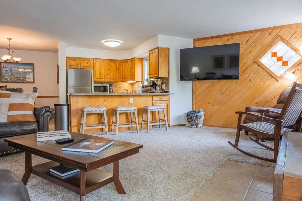 Open living room with 65" smart TV and gas fireplace. 
