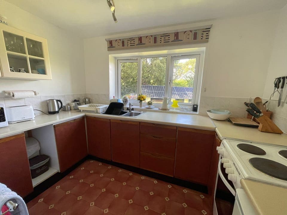 Kitchen with accessories including cooker, fridge, microwave, kettle, toaster...