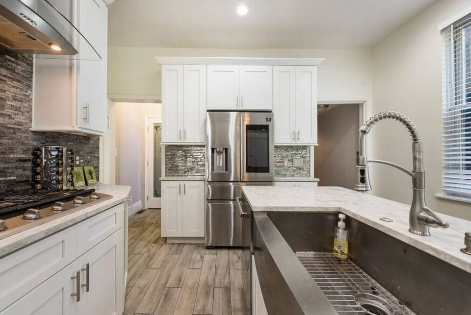 Walk down the hall from the dining room, and suddenly you`ll discover a bright, sleek, and modern kitchen.