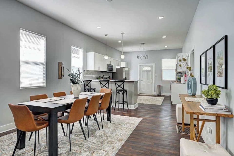 The spacious dining area comfortably seats eight, with three additional seats at the bar top, making it ideal for group gatherings. The seamless flow between the kitchen and dining area allows for easy entertaining and a connected, open feel.