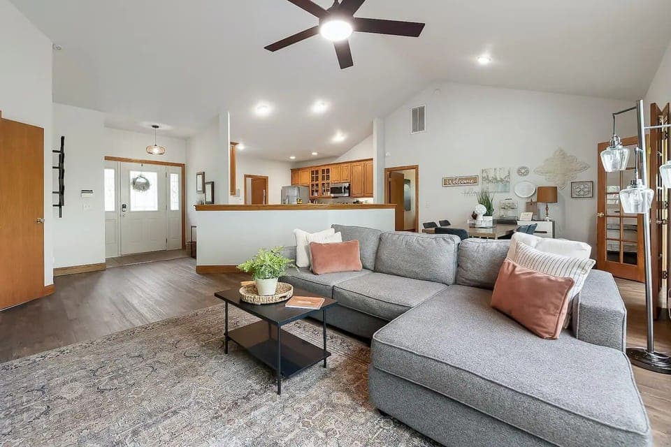 Relax in the light-filled spacious main level living room with vaulted ceilings